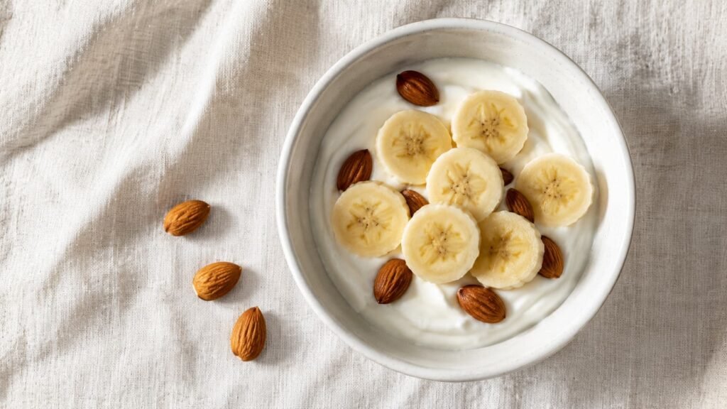 banana slices with yogurt and almonds as a sleep-friendly bedtime snack